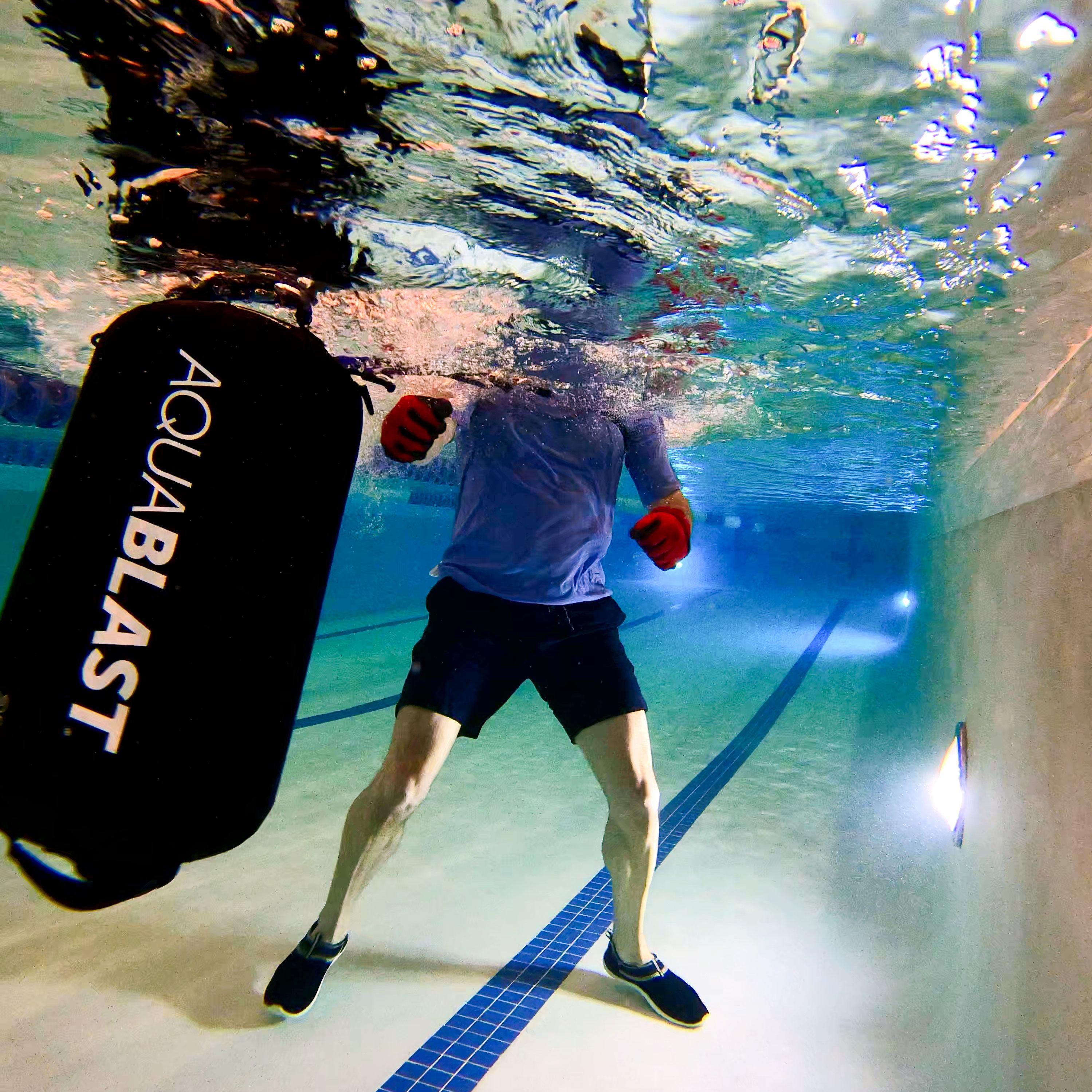 kickboxing with aquablast using the harness system for tether low impact fitness in the pool